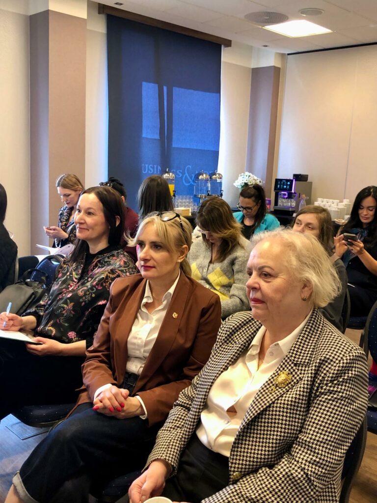 Sala konferencyjna. Uczestnicy konferencji, wśród nich jest uśmiechnięta Basia Górka z Fundacji Imago. 